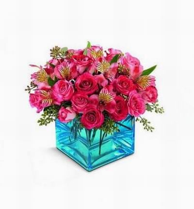 Pink spray roses and alstroemeria share their world with this square glass vase.