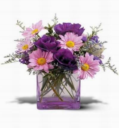 Daisies Statice and Lisianthus arranged in a keepsake gift vase.