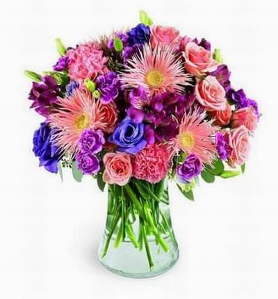 Pink spider Gerbera daisies and pink spray roses gaily dance with rosy purple alstroemeria and double purple lisianthus.