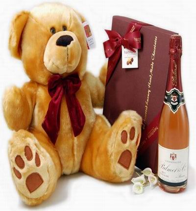 Champagne,a box of chocolates, and a 30 cm teddy bear. Champagne based on local selection. Brands will vary.  (Photo image is only an example)