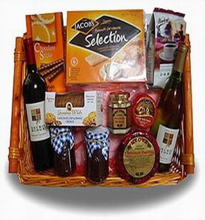 Bottle of red and white wine, 2 jars of jam, cheese, cookies, biscuts, coffee beans. and seasoning. Wine based on local wine selection. Brands will vary.  (Photo image is only an example)