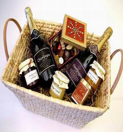 Two bottles of Champagne with strawberry and orange jam, mustard, box of candies and chocolates. Champagne based on local selection. Brands will vary.  (Photo image is only an example)