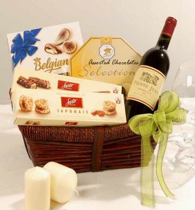 A bottle of red wine, two boxes of biscuts, Belgian chocolates, and a box of assorted chocolates. Wine based on local wine selection. Brands will vary.  (Photo image is only an example)