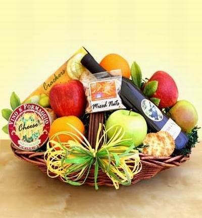 Fruit basket with 2 red Apples, 2 green Apples, 2 Oranges, Crackers, Cheese, Mixed Nuts and red Wine.