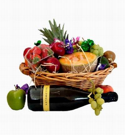 Fruit Basket of 1 Pineapple, 2 red Apples, 1 green Apple, 1 Cantaloupe, 1 Avocado and 8 Strawberries with one bottle of red Wine.