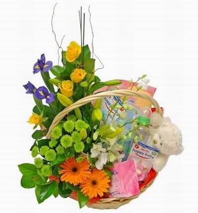 Flower basket of 4 yellow roses, 3 Iris, 2 Daisies, green fillers with two Baby Bottle, Baby wipes, Baby lotion and a 15 cm Teddy Bear.