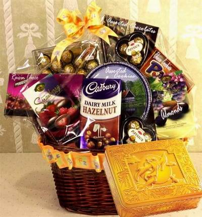 A box of Premium Mooncakes and a Gift Basket with Ferrero Chocolates, 24 pcs, two small Ferrero Chocolate packages of 3 pcs each, a Raisin Chocolates, Strawberry Chocolate bar, and Dairy Milk Hazelnut Chocolate bar. Also with an assorted mix of cookies