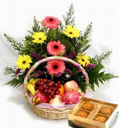 A box of Standard Mooncakes and a Flower basket of 3 pink and 4 yellow Gerebera Dasies, stock and Greenery fillers with 2 Dragon Fruits, 2 red Apples, 1 Orange, 3 Bananas and Grapes.