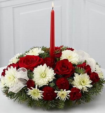 3 Rich red roses, 10 burgundy mini carnations, 10 white cushion poms, cedar stems and assorted holiday greens.