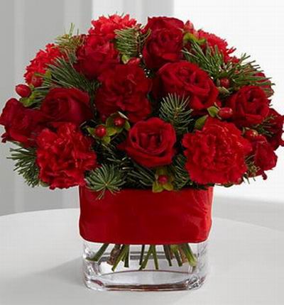 10 Bright red spray roses, 5 red mini carnations, red hypericum berries and assorted holiday greens.