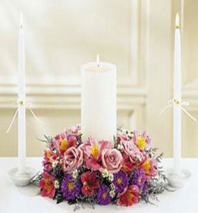 Pink Roses,pink Orchids,purple Chrysanthemum and white candle mix display