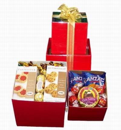 A box of Tart Cookies, Chocolate Chip Cookies, two 3pc Ferrero Chocolates, two bags of Chips surrounded by Assorted Candies.