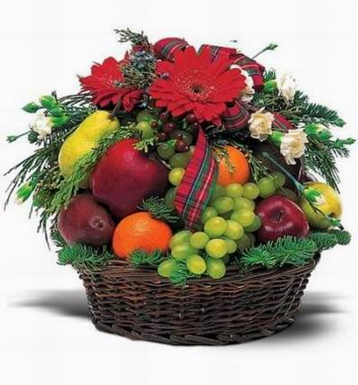 Fruit basket of 3 red Apples, 2 Pears, 2 Oranges, Grapes with 5 white Carnations, 3 red Gerbera Daisies and Greenery.