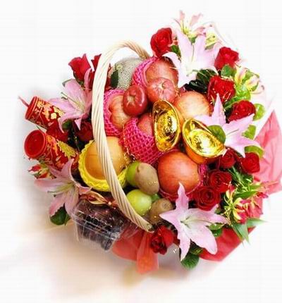 Lunar New Year Fruit basket filled with 5 red Apples, 2 kiwis, 2 Wax Apples, a Pear and Cantaloup surrounded by 12 red Roses and 5 pink Lilies..