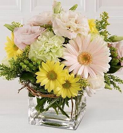 2 pink gerberas, 6 pink eustomas, 3 white carnations, yellow daisies and green in vase