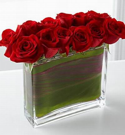 12 Roses in a slim rectangular vase.