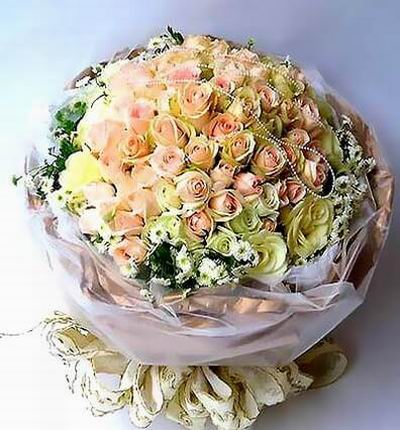 50 cream Roses and 49 light pink roses with white Daisy Poms and greenery.