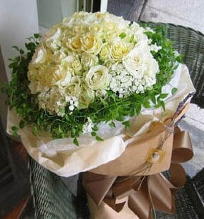 36 white/cream Roses with Baby's Breath and greenery.