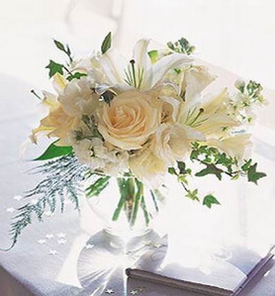 5 cream white Roses, 3 white Lilies and fillers