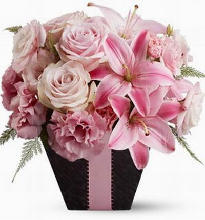 6 pink Roses, 3 pink Lilies, 6 pink Carnations in a black box. If boxes are not available, a square cube vase can be used wrapped in black paper.