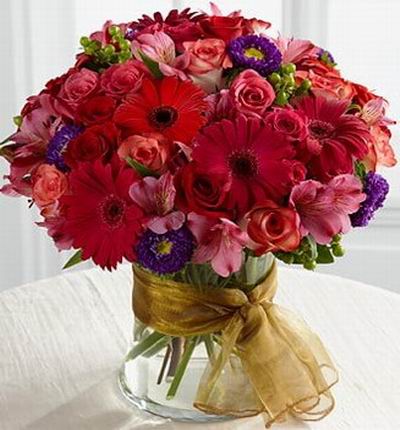 10 red and pink roses, 5 red Gerbera Daisies, 8 Alstromerias, 4 purple ball poms and greenery.