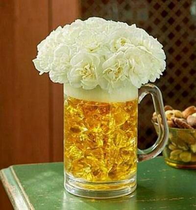 White mini carnations in an acrylic beer mug, with special acrylic rocks to symbolize their favorite brew. (if beer mug is not available, a clear vase will be substituted)