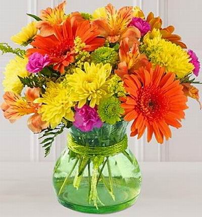 3 orange Daisies, 5 yellow Spider Mums, 6 Alstromerias, 4 purple Carnations with Poms and Greenery fillers.