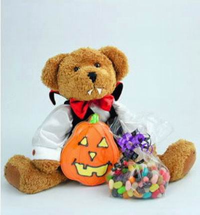 A 30 cm bear dressed up for Halloween and some candy treats.