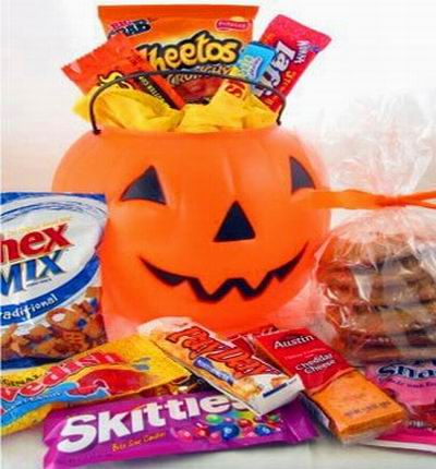 A pumpkin full of candy and chips